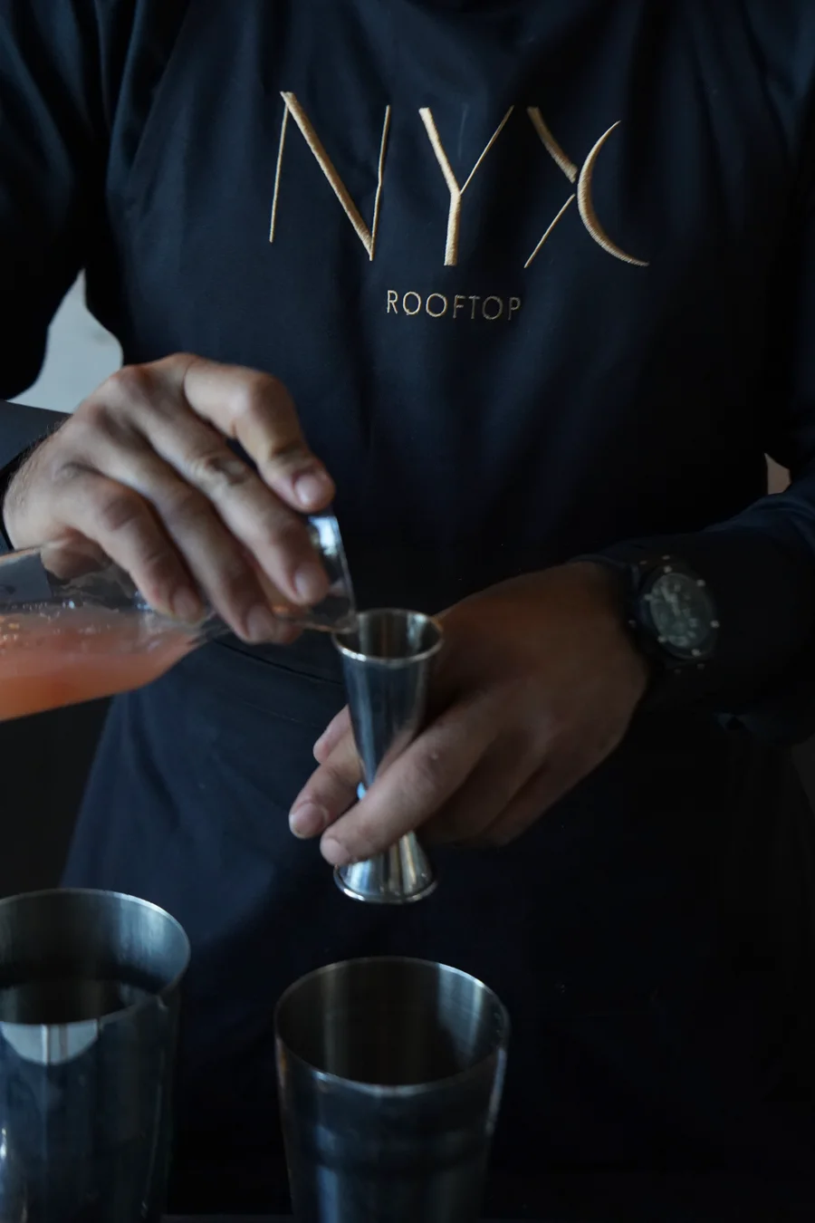 NYX Rooftop bartender crafting a cocktail